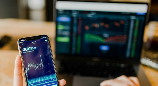 financial charts with a Bitcoin symbol overlay